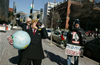 A protester dressed as George W. Bush gives an oil drinking theater protest outside the offices of the American Enterprise Institute the day after Bush's inauguration for a second term.