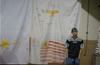 A teenager watches the Military Mayhem wrestling event at the Linton, Ind., National Guard Armory.