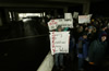 Anti-Bush protesters wait at a checkpoint to gain entry to Pennsylvania Avenue where President George W. Bush would be parading past during his second inauguration.