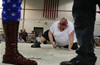 Wrestler “Ed Morbid” tries to get up after being clobbered with a barbed-wire club during the Military Mayhem wrestling event at the Linton, Ind., National Guard Armory. The amateur hardcore wrestling event raised $968 for the National Guard.