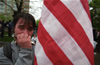 An anti-Globalization protester play harmonica after police used pepper spray on protesters during a meeting of the IMF and the World Bank in Washington, D.C. April 16, 2000