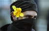 A Black Bloc Anarchist wears a flower during the IMF and World Bank protests Washington D.C. April 16, 2000