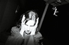 Ray's sister covers her ears during a party at some guy's house up in the mountains. Ray was a skinhead and we weren't always down with his politics. Actually, a friend of mine got into a fist fight with him one night at suburban house party. They rolled around in the backyard with their Doc Martins sticking up in the air cussing at each other, trying to hit each other and calling each other names. 1993